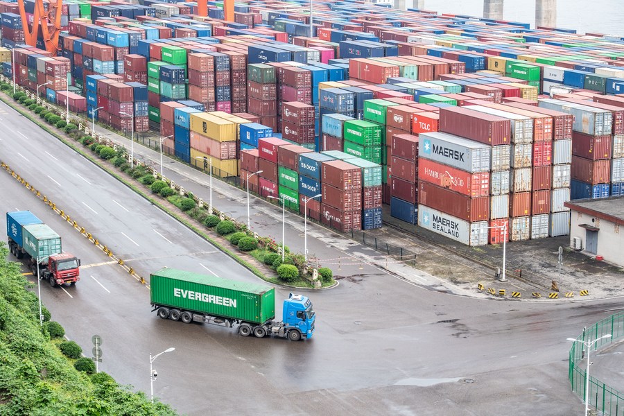 Container vengono trasportati da camion al porto di Guoyuan, a Chongqing, nel sud-ovest della Cina. (20 aprile 2023 - Xinhua/Tang Yi)
