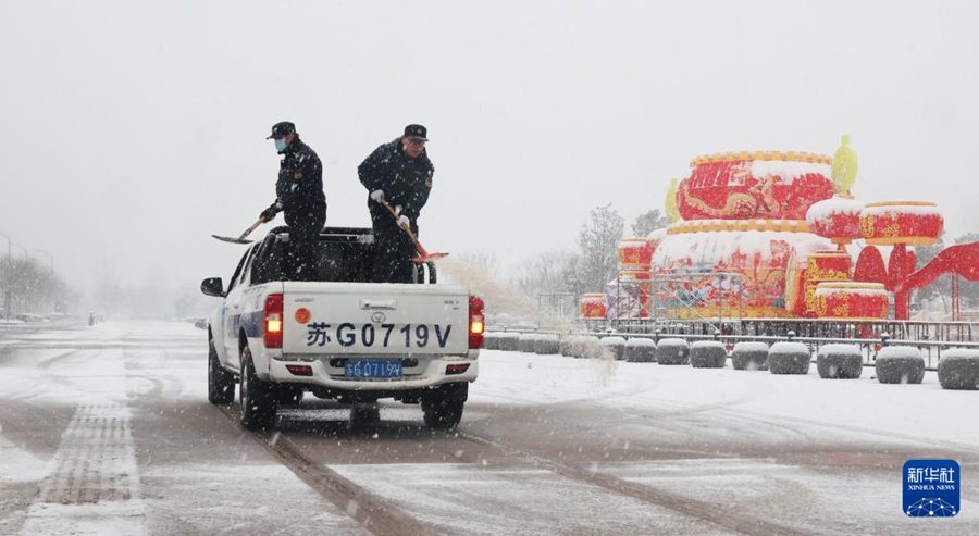 Personale della gestione urbana sparge un agente per lo scioglimento della neve sulla Chaoyang East Road, nel distretto Haizhou della città di Lianyungang, provincia del Jiangsu. (4 febbraio 2024 – Xinhua/Geng Yuhe)