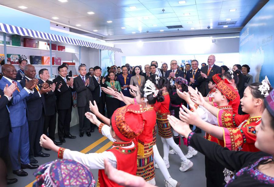 Il Ministro degli Esteri cinese Wang Yi, membro dell'Ufficio Politico del Comitato Centrale del Partito Comunista Cinese, assiste a un'esibizione con i partecipanti a un evento promozionale organizzato dal Ministero degli Esteri per presentare al mondo il porto di libero scambio di Hainan. (4 dicembre 2024 - Xinhua/Pang Xinglei)