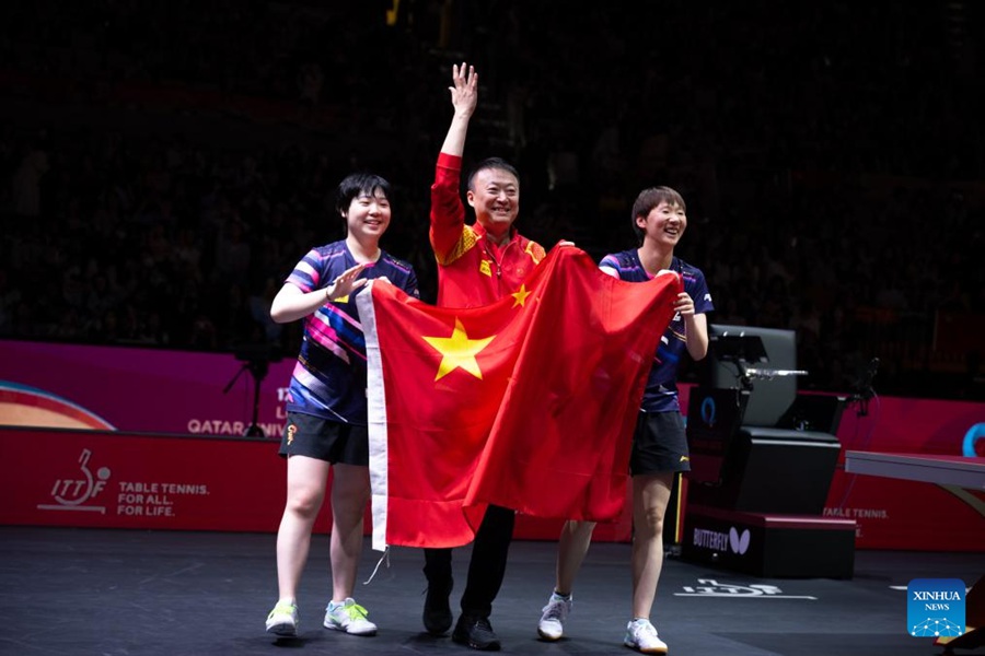 Wang Manyu (a destra) e Kuai Man (a sinistra) festeggiano con l'allenatore Ma Lin dopo la finale del doppio femminile dei Campionati Mondiali di Tennistavolo ITTF Doha 2025, a Doha, Qatar. (25 maggio 2025 - Xinhua/Xiao Yijiu)