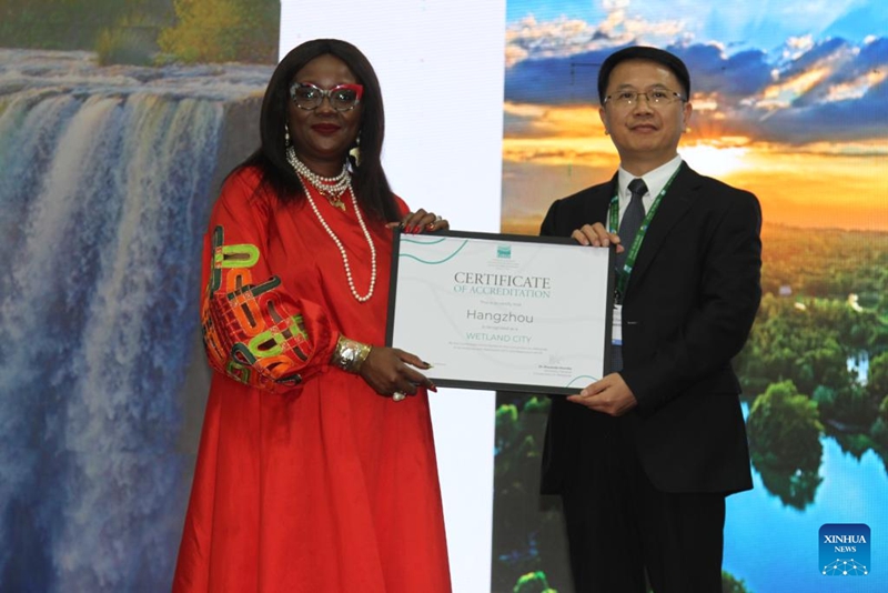 Musonda Mumba (a sinistra), segretaria generale della Convenzione sulle Zone Umide, consegna un certificato di accreditamento internazionale di città delle zone umide a un rappresentante di Hangzhou, provincia del Zhejiang, nella Cina orientale, a Victoria Falls, Zimbabwe. (24 luglio 2025 - Xinhua/Tafara Mugwara)