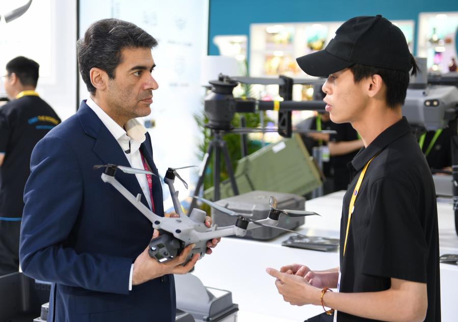 Un membro dello staff presenta un prodotto a un visitatore presso lo stand DJI alla quinta edizione della China International Consumer Products Expo (CICPE) ad Haikou, nella provincia di Hainan, Cina meridionale. (15 aprile 2025 - Xinhua/Sun Xiaotian)