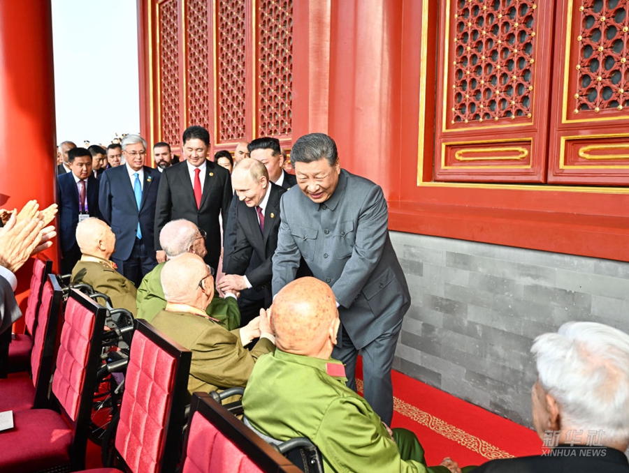 Il Presidente Xi Jinping saluta i veterani dalla tribuna di Tiananmen
