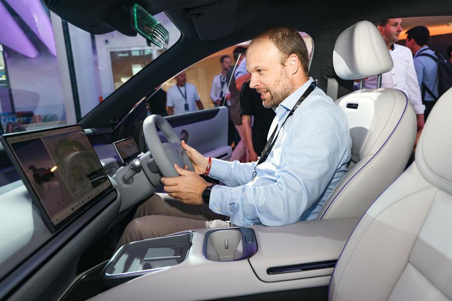 Un uomo prova la nuova auto MONA L03 di XPENG durante un evento di presentazione a Monaco di Baviera, in Germania. (16 luglio 2026 - Xinhua)